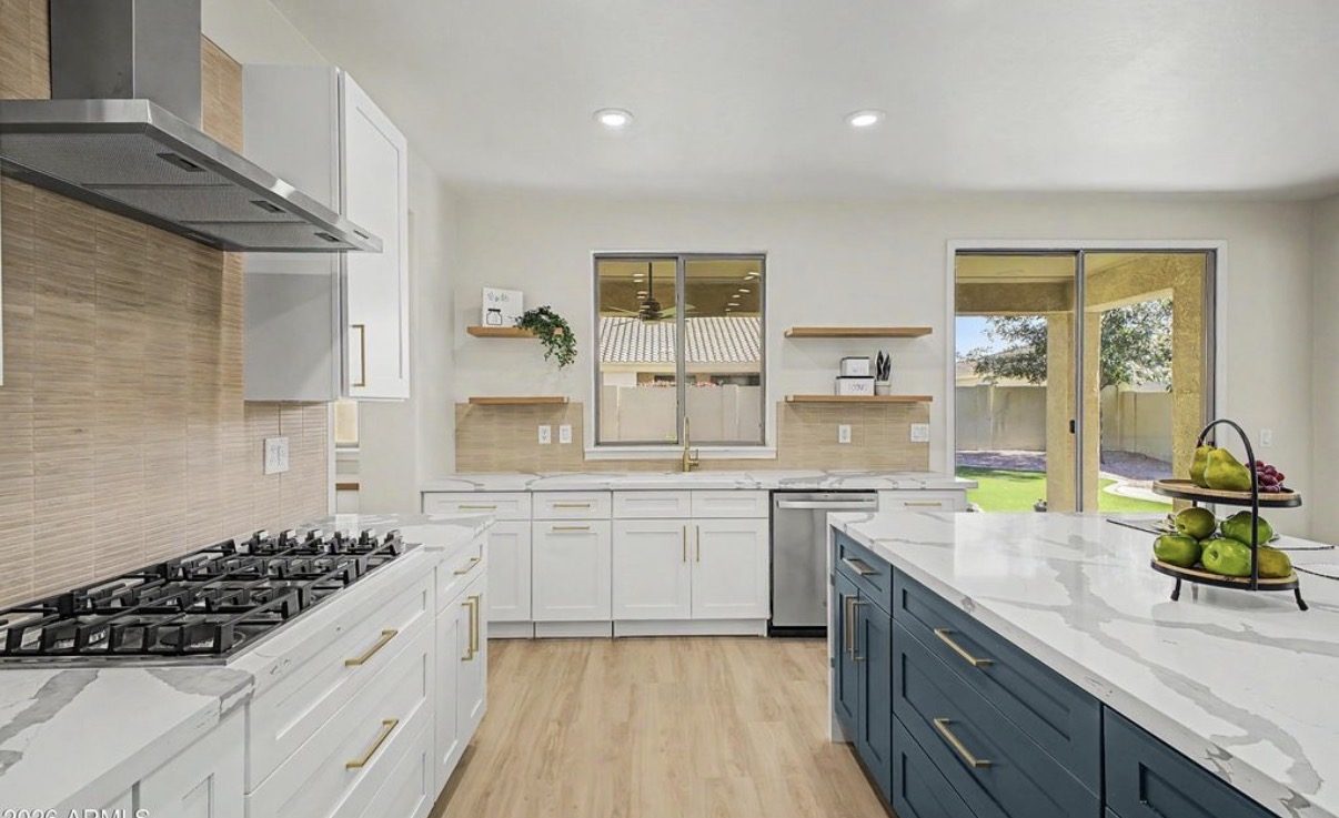Custom kitchen with white and navy cabinetry and gas cooktop