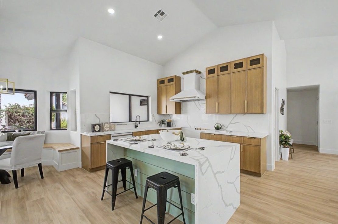 Custom kitchen with white oak cabinetry and sage green island